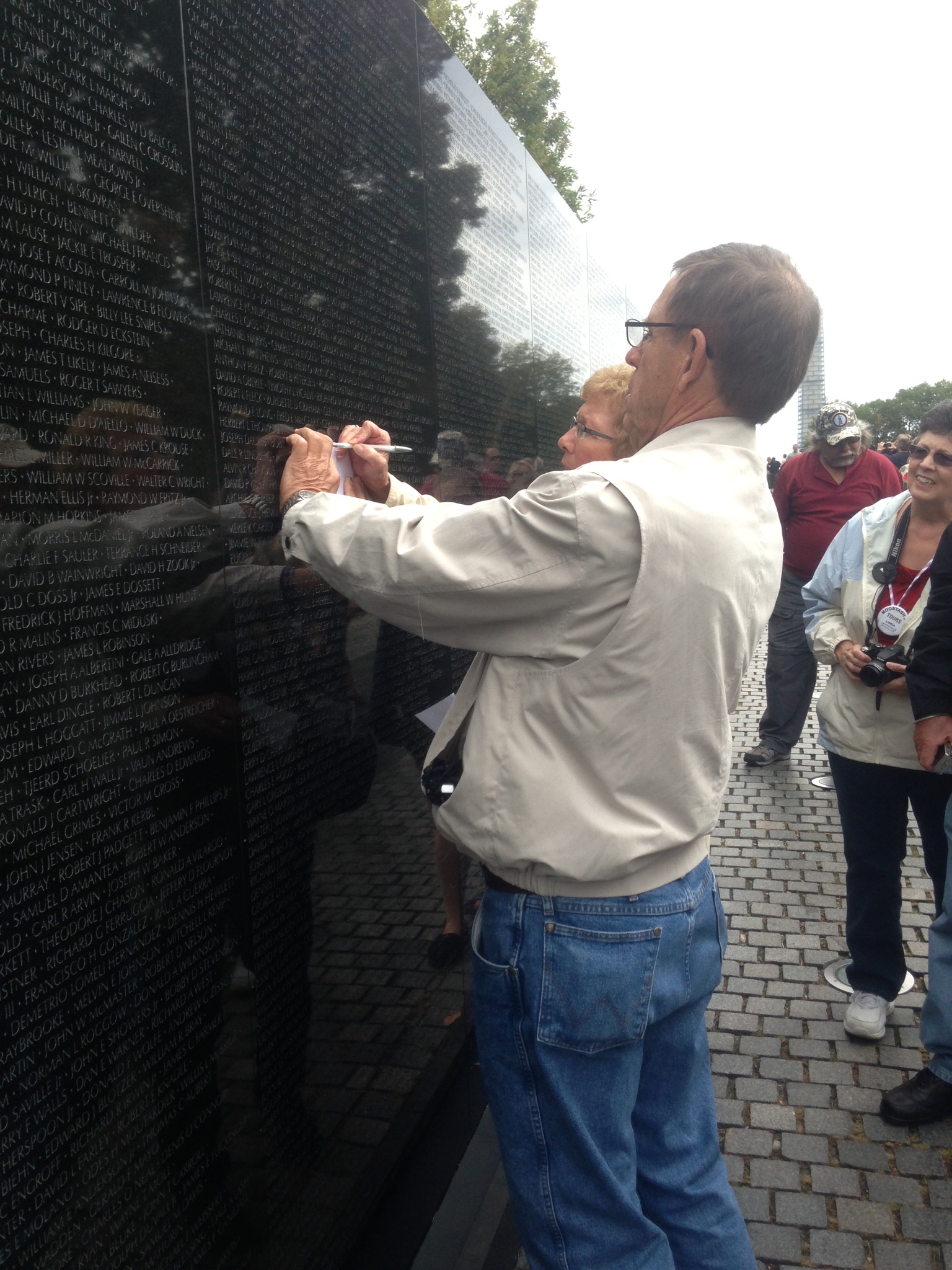 Tracing a name of a family friend at the Vietnam Memorial